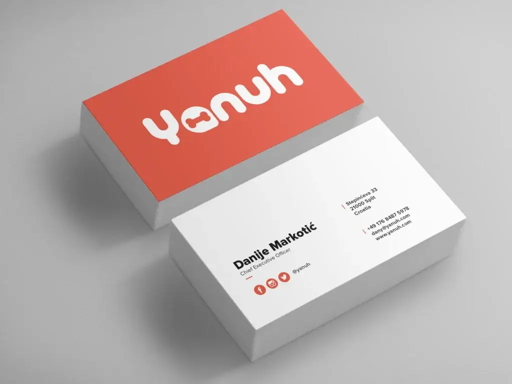Yanuh logo on red and white business cards